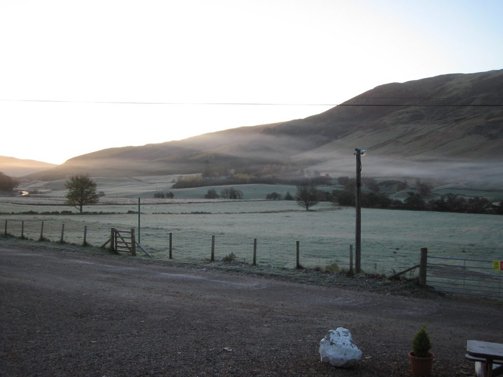 Frosty morning in hilly countryside landscape.