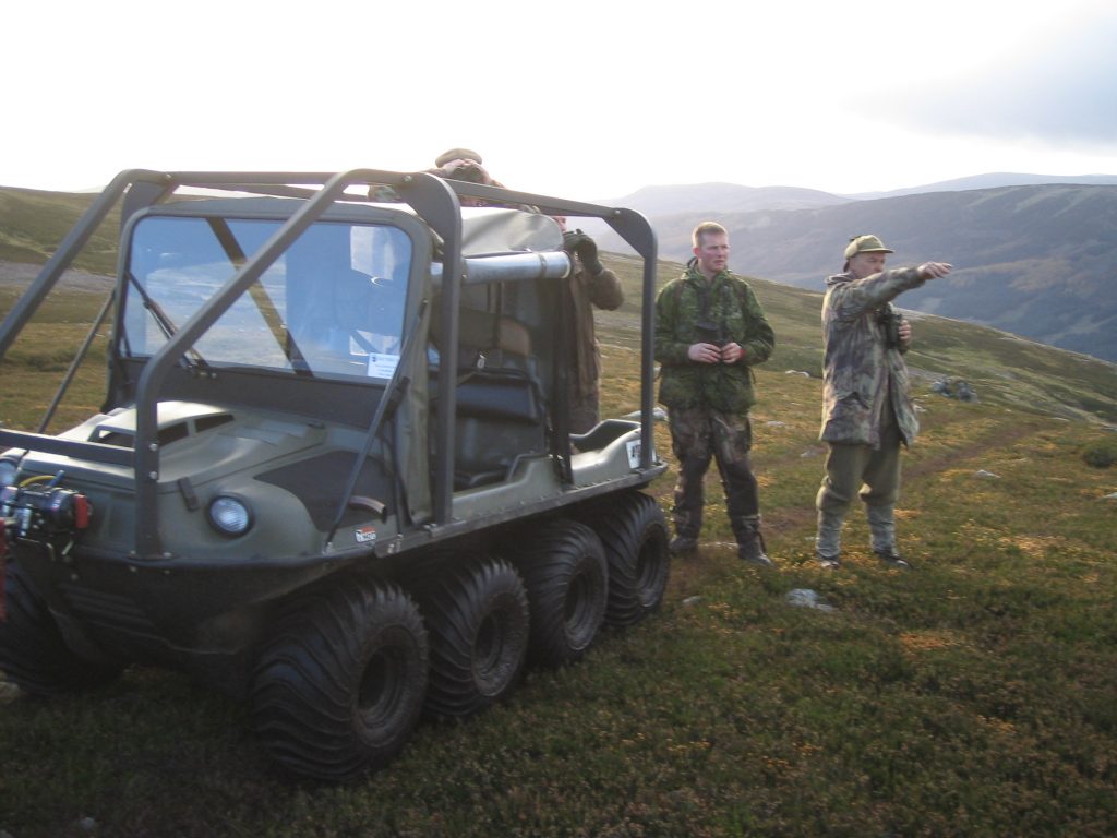 Off-road vehicle with people in outdoor gear