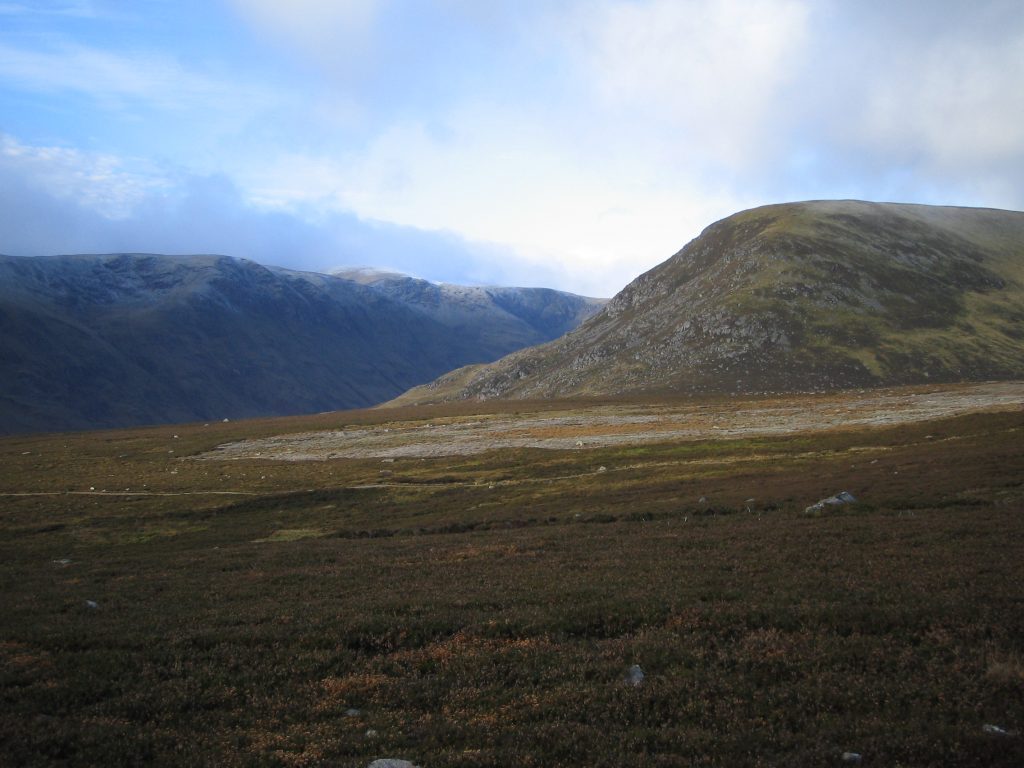 Scenic view of Scottish mountains under cloudy sky.