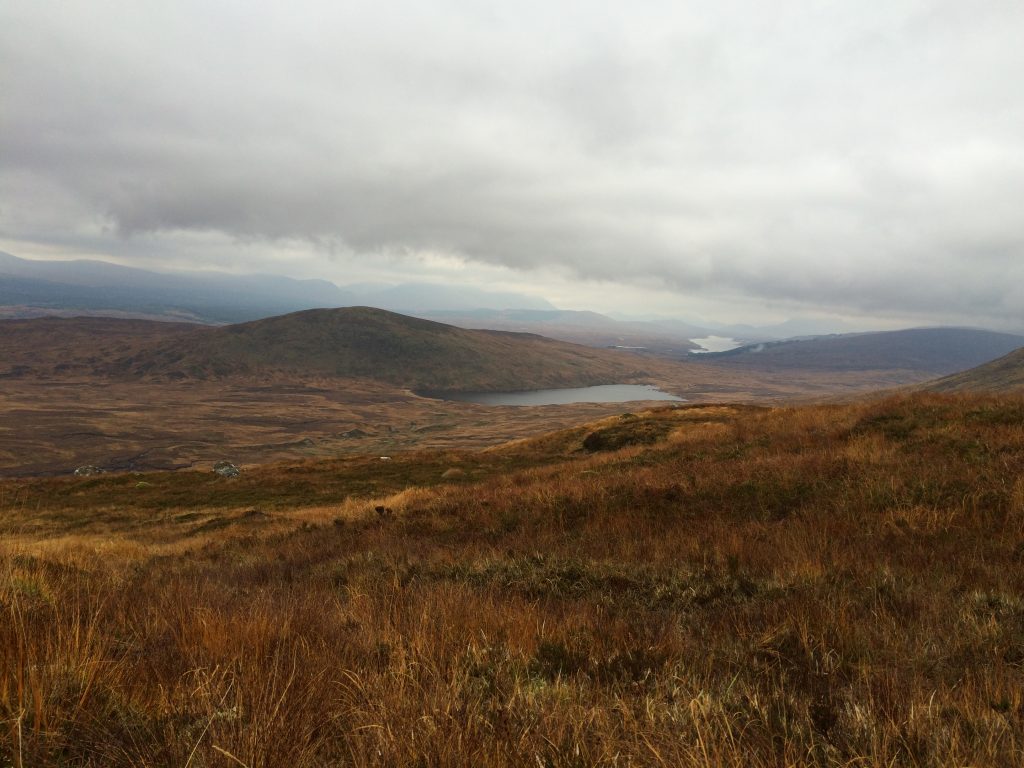 Cloudy sky over Scottish Highlands landscape.